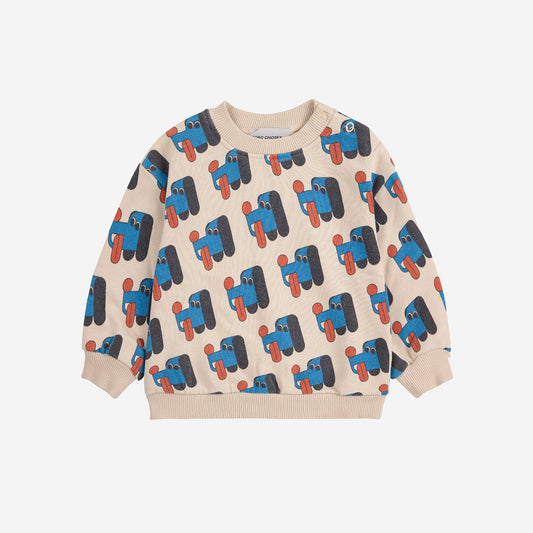 Children's sweater with dog pattern on a beige background