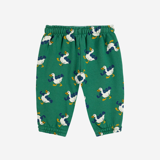 Green children's pants with duck pattern on a white background