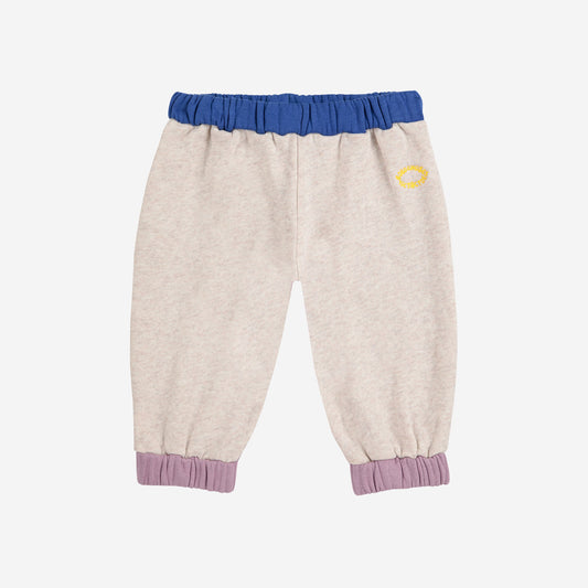 Beige pants with blue and purple accents on a light gray background