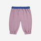 Pink baby pants with blue waistband on a white background