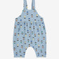 Blue children's overalls with a pattern of small figures on a white background