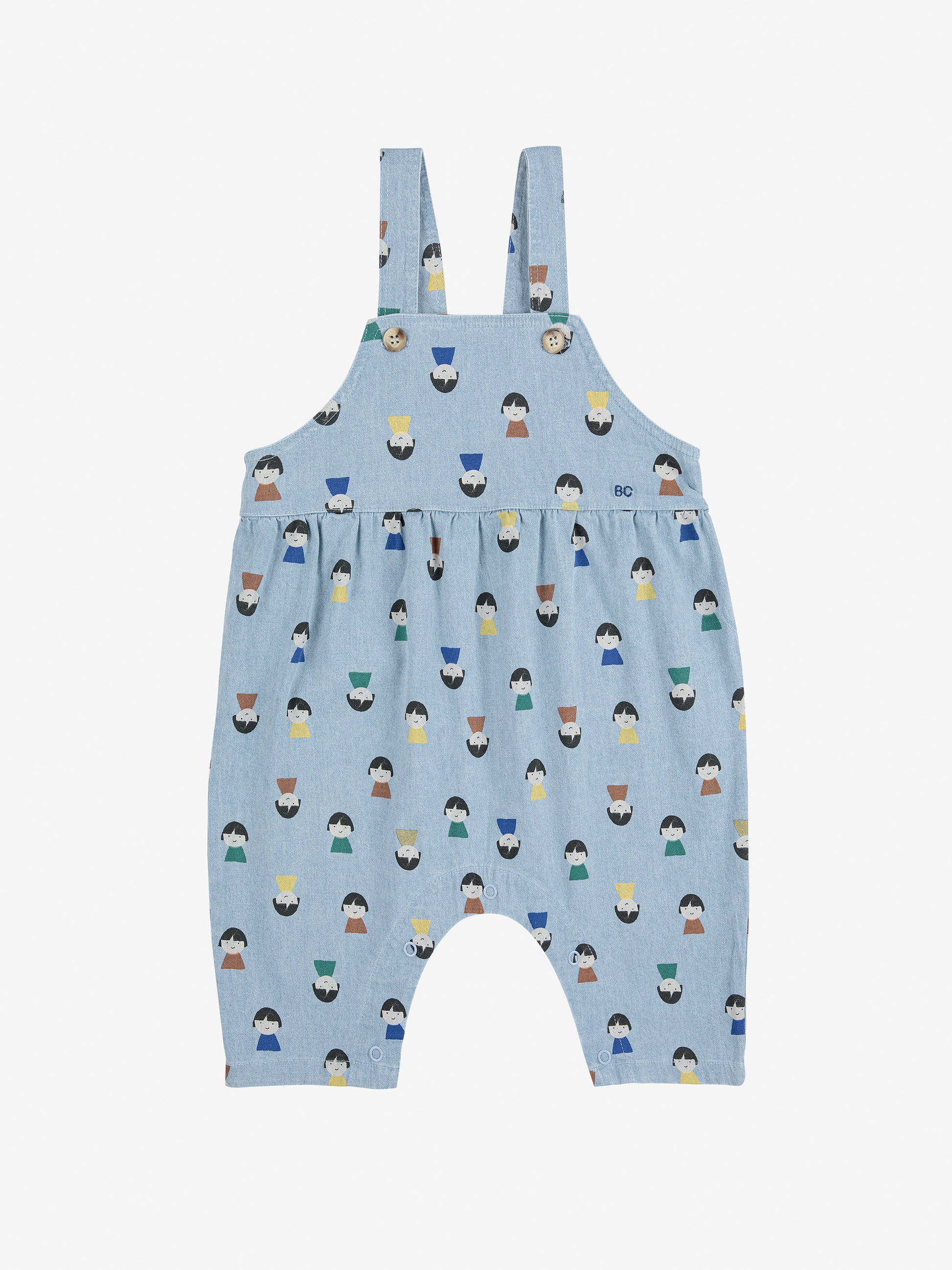 Blue children's overalls with a pattern of small figures on a white background