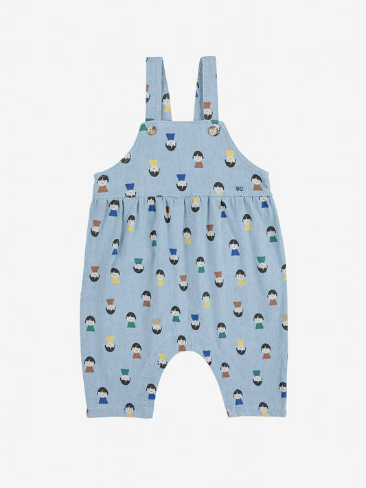 Blue children's overalls with a pattern of small figures on a white background