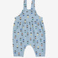 Blue children's overalls with colorful pattern on a white background