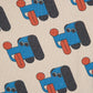 Pattern of blue dogs with red accents on a beige background