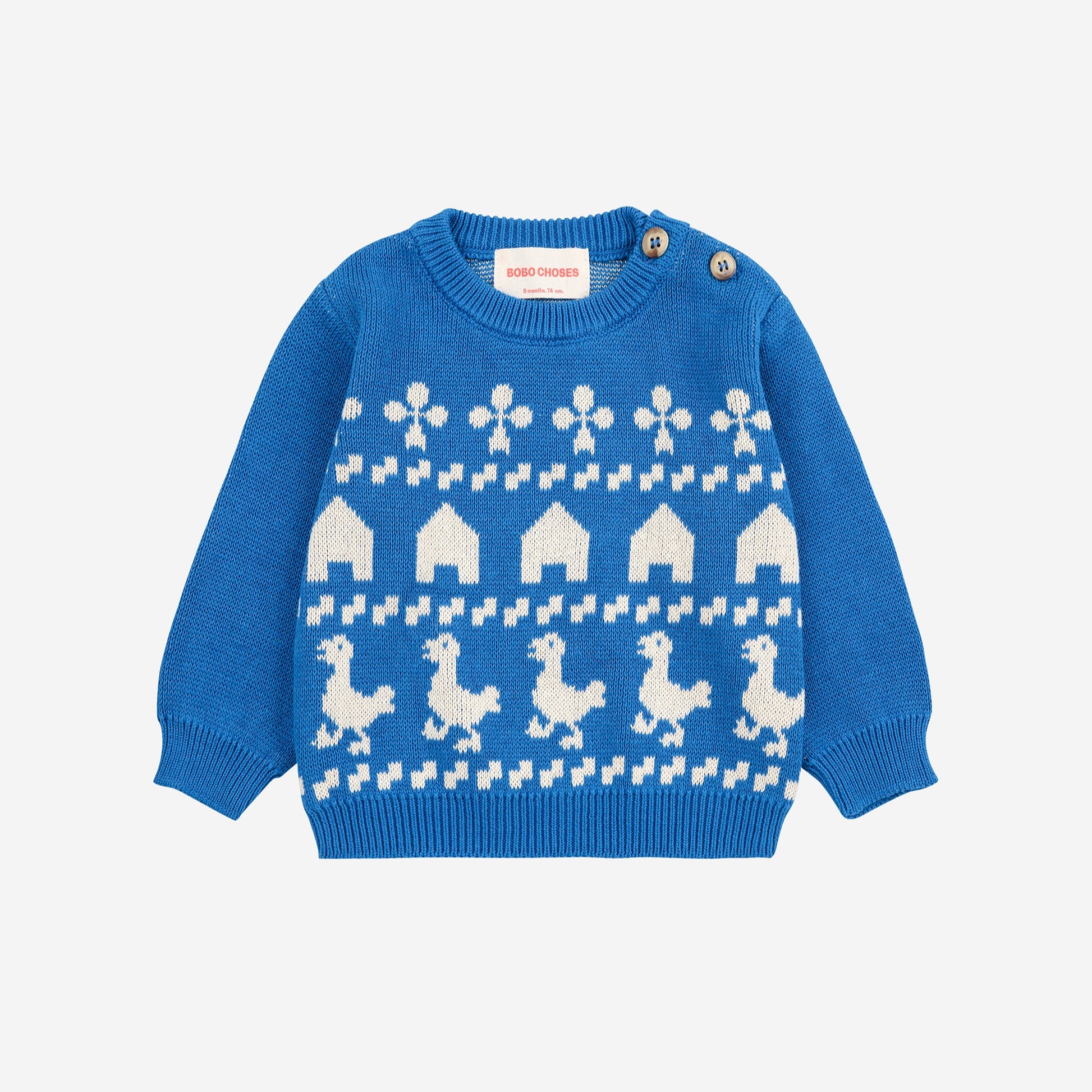 Blue sweater with white pattern on a light gray background