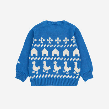Blue sweater with white pattern on a light gray background
