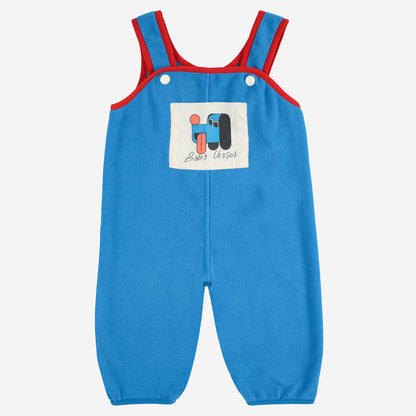 Blue dungarees with red straps on a white background