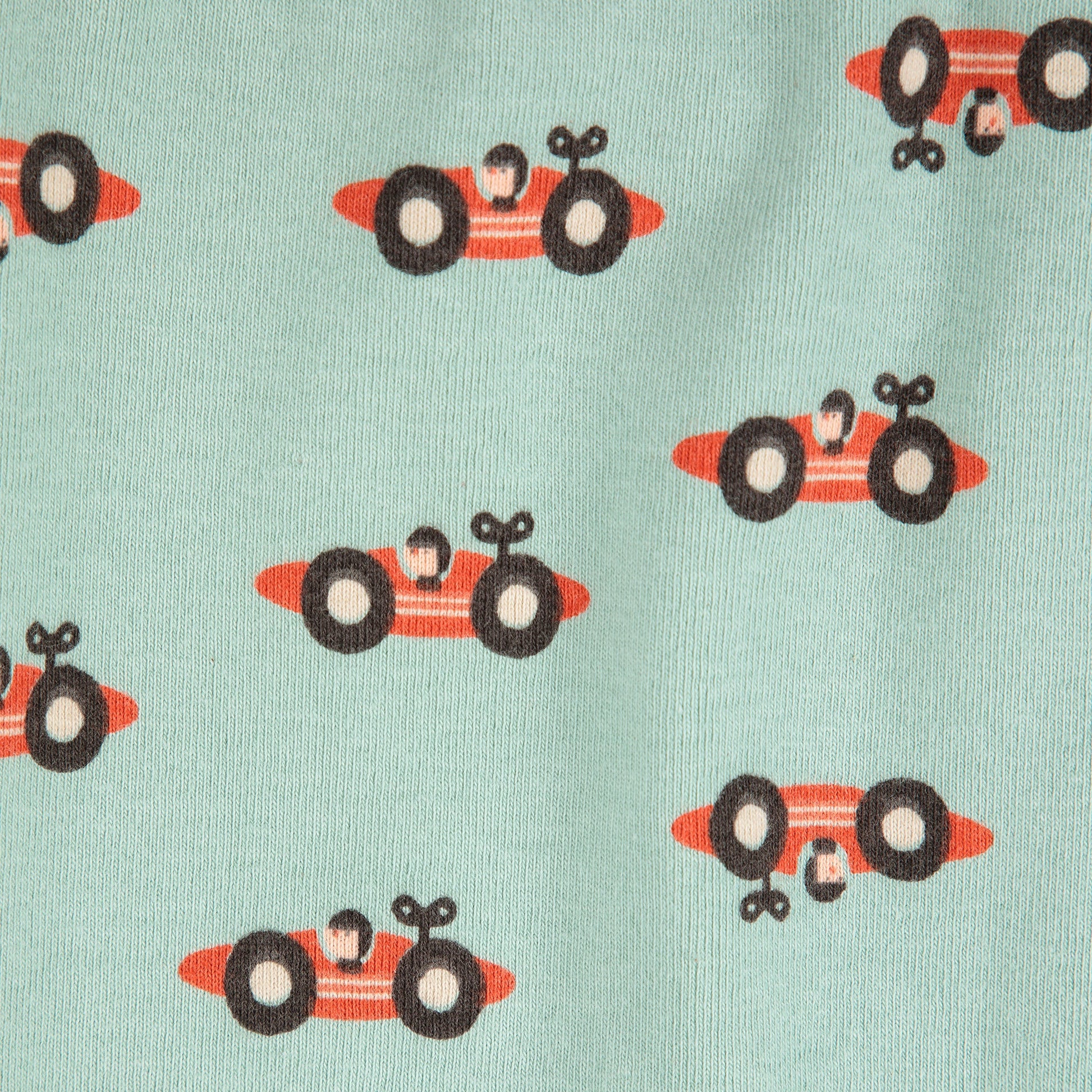 Pattern of red race cars with black wheels on a light blue background