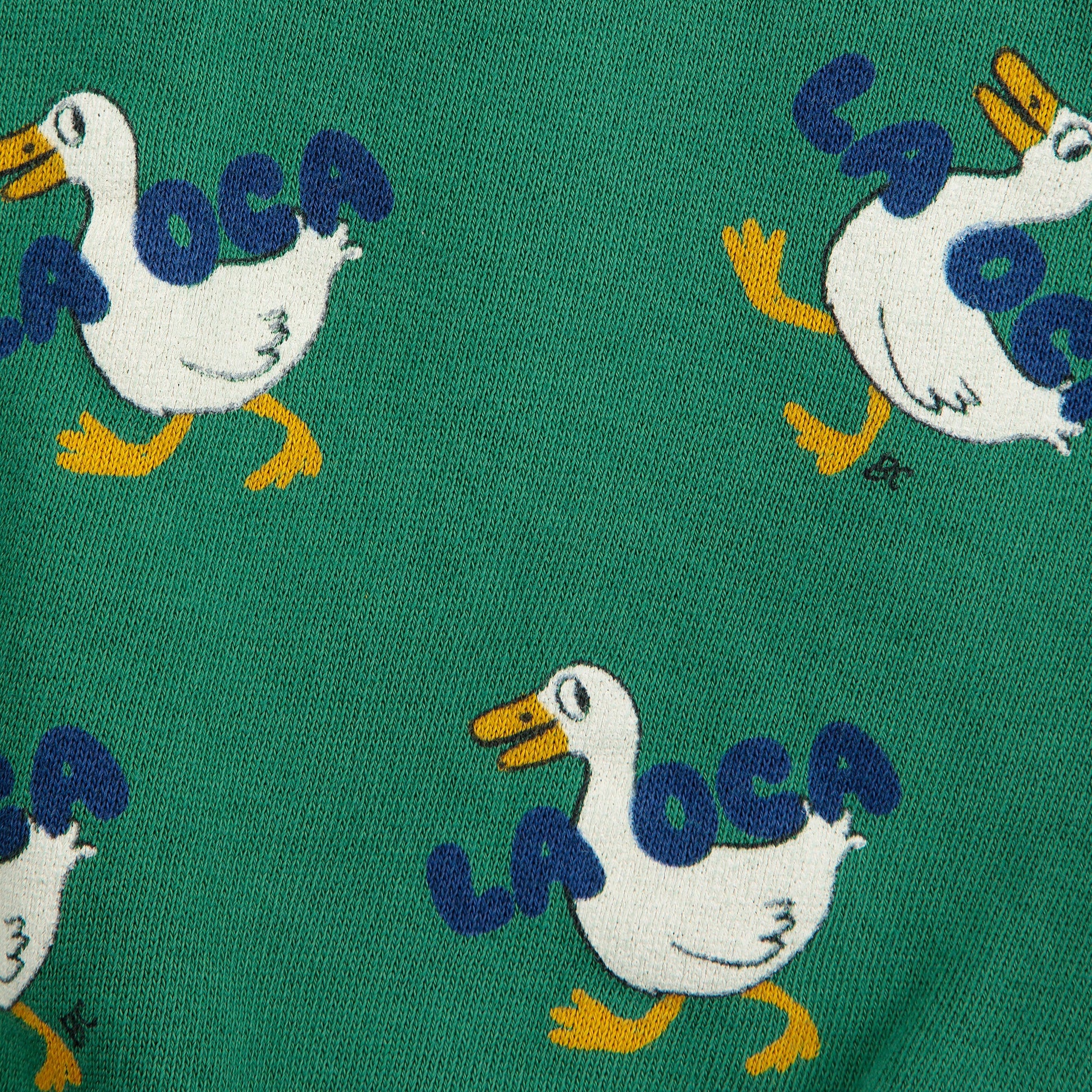 Pattern of cartoon ducks with 'Laoca' text on a green background
