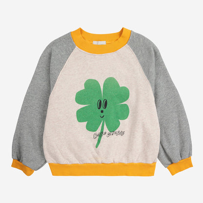 Children's sweatshirt with a smiling four-leaf clover design on a white background