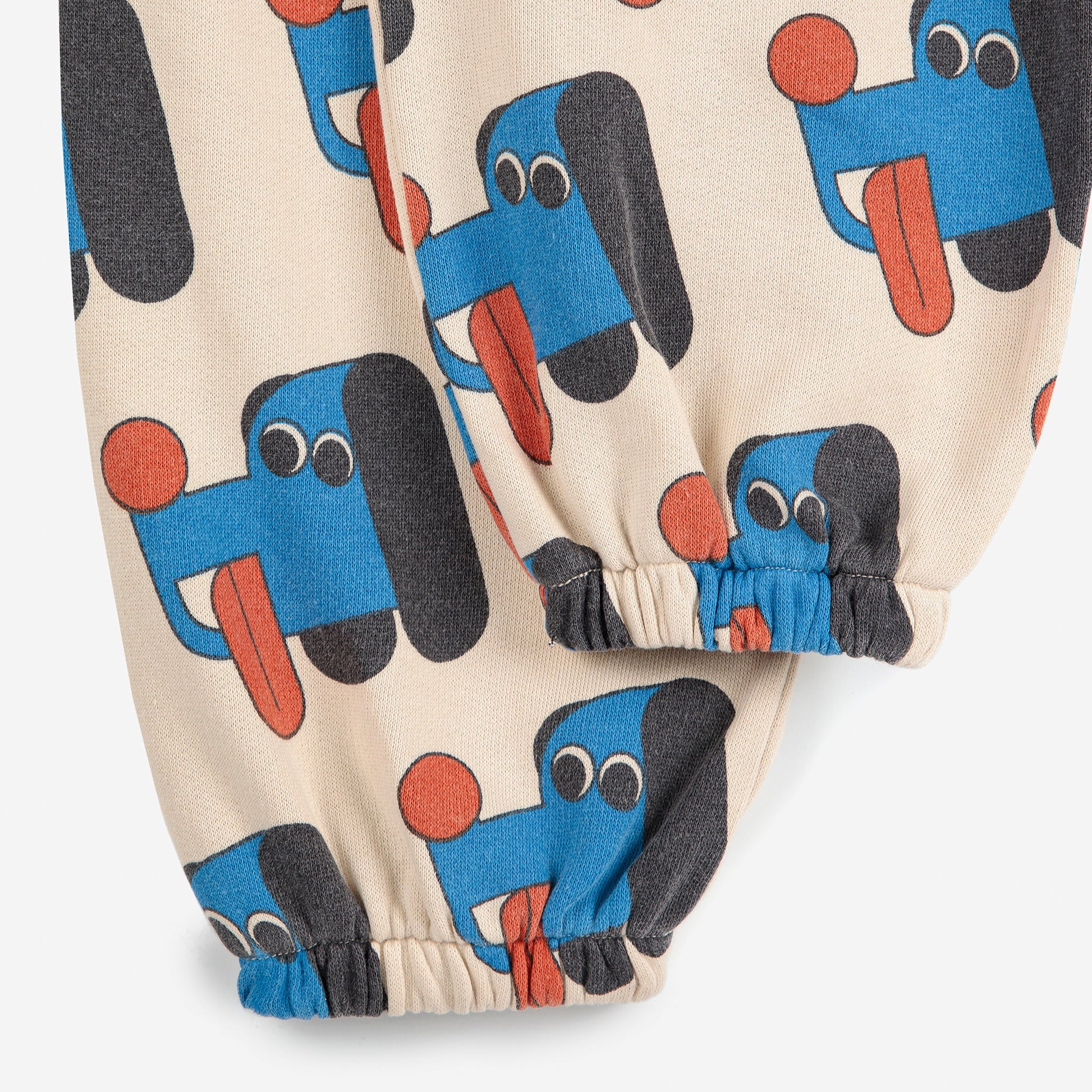 Children's pants with blue dog pattern on a beige background