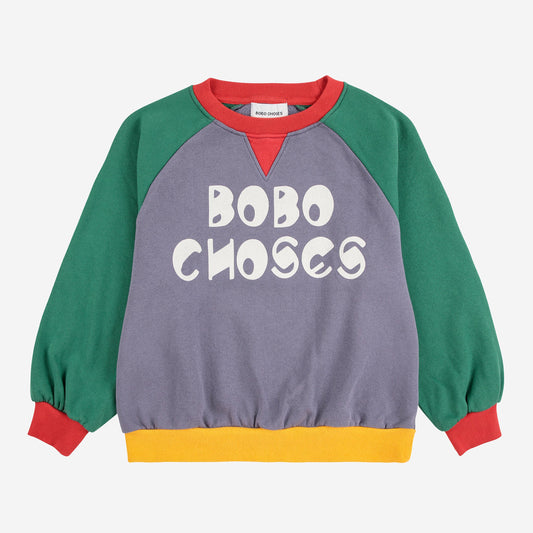 Colorful sweater with 'BOBO CHOSES' text on a white background
