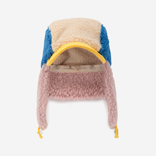 Multicolored fleece-lined hat with ear flaps on a white background