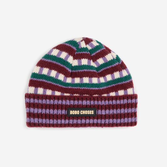 Multicolored striped beanie with a brand logo on a white background