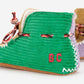 Green slippers with 'BC' initials on a white background