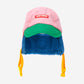 Colorful winter hat with pink top, green middle, blue bottom, and yellow ear flaps on a white background.