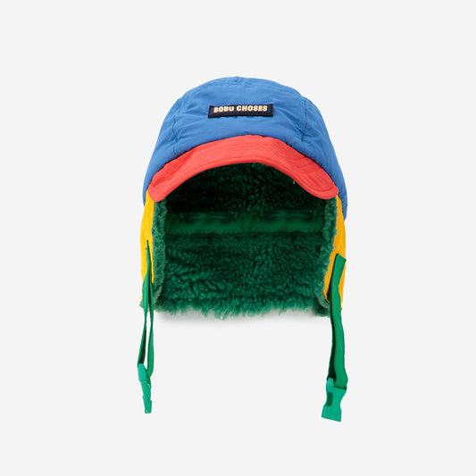 Multicolored winter hat with a green interior on a white background