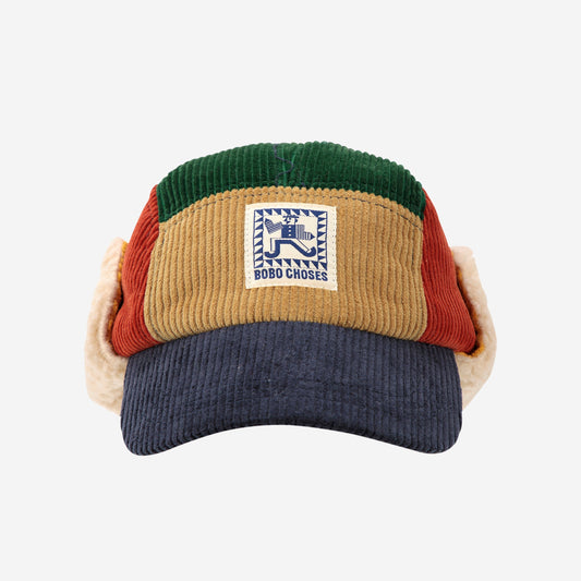 Colorful visor cap with a patch on a white background