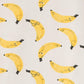 Pattern of yellow bananas with black stems on a light background