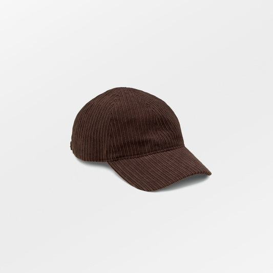 Becksöndergaard Malvi Cap in Hot Fudge Brown, made from ribbed velvet corduroy, featuring an adjustable strap and a discreet logo at the back. The cap is showcased on a neutral background, highlighting its stylish design and unisex appeal.
