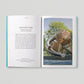 Open book showing text and a photograph of a modern playground structure.