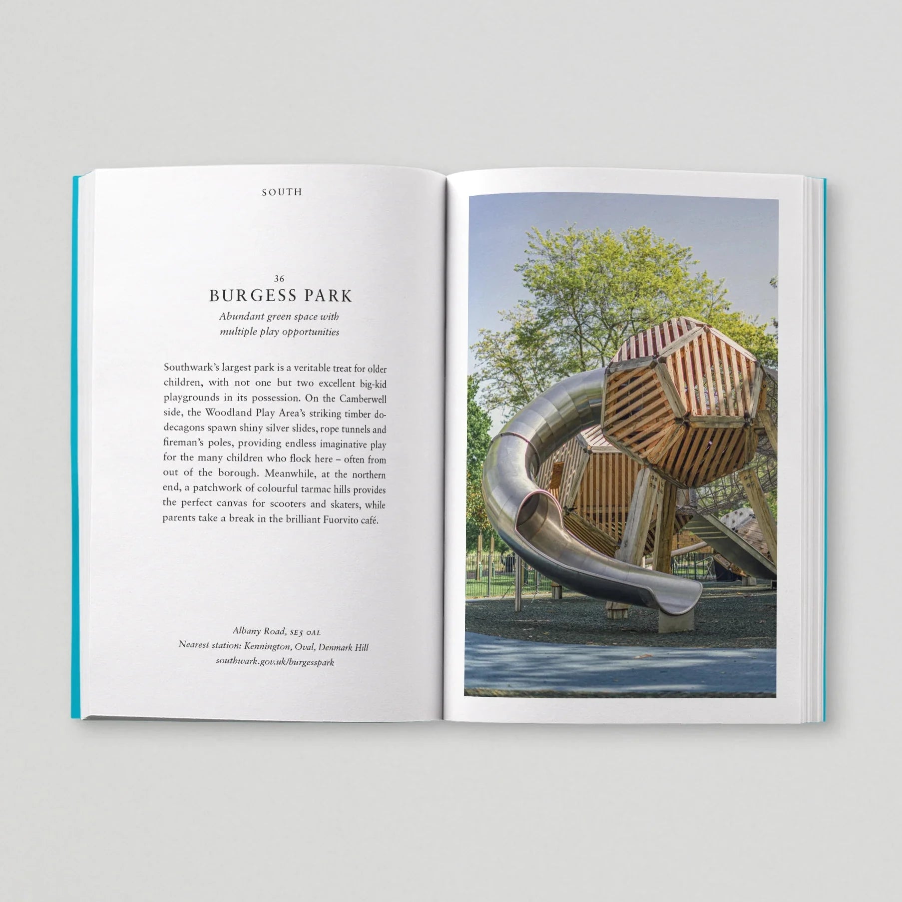 Open book showing text and a photograph of a modern playground structure.