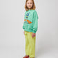 The model poses in a three-quarter stance, showing the sweatshirt's relaxed fit and dropped shoulders.