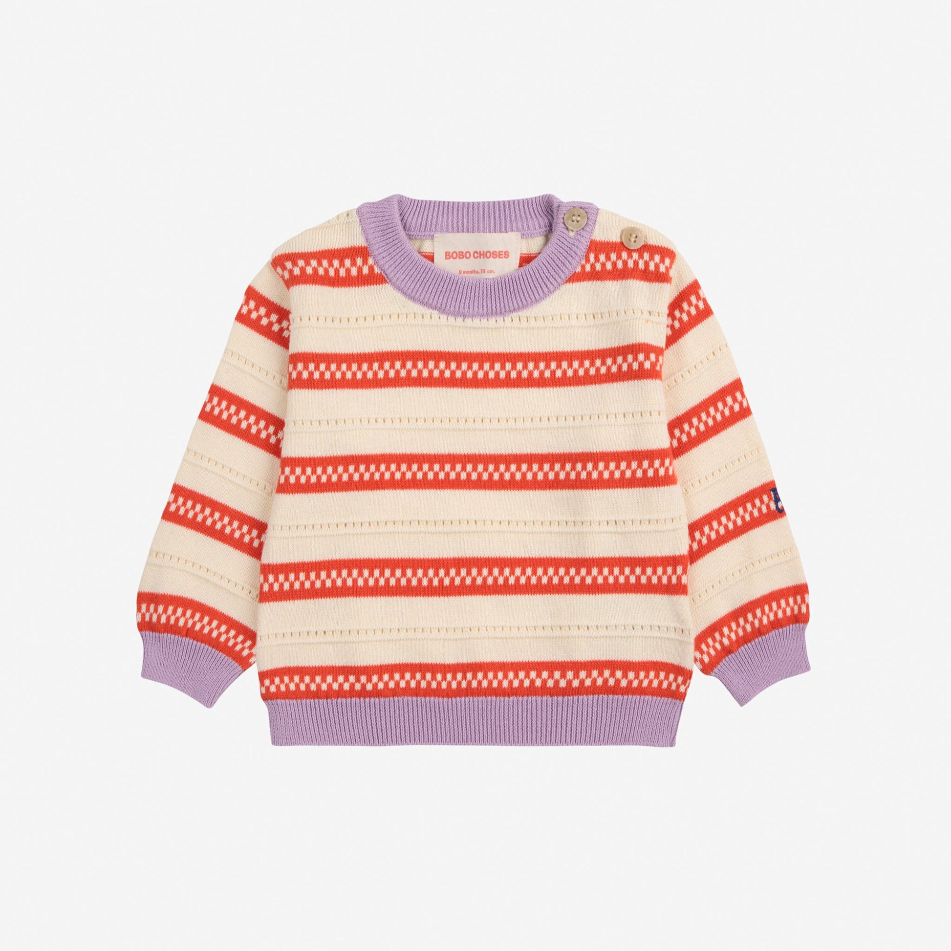 A knitted baby jumper with a vintage-inspired striped pattern in cream and orange. It features lilac ribbed trim at the neckline, cuffs, and hem, with two button fastenings on the shoulder for easy dressing.
