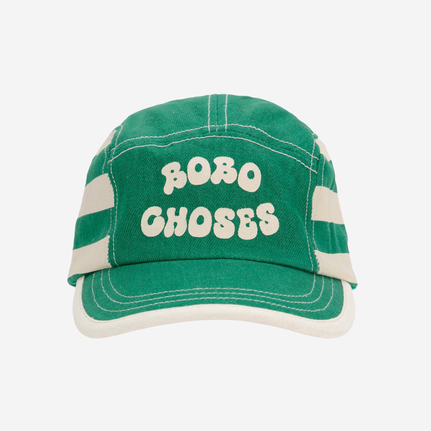 The front view of the green Bobo Choses cap, featuring its structured crown, bold cream lettering, and curved visor with contrast white stitching.