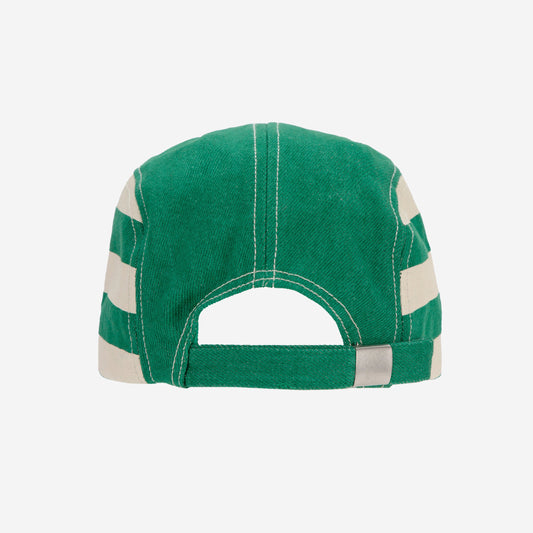 The back view of the green Bobo Choses cap, showing the adjustable strap with a metallic buckle and an open-back design. The cream stripes continue around the sides.