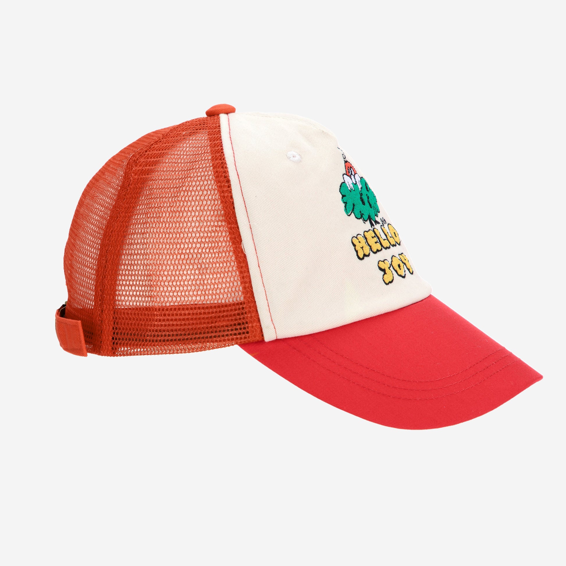 A side view of the Bobo Choses "Hello Joy" mesh cap, showing its structured cream front panel, red curved brim, and breathable orange mesh back with an adjustable strap.