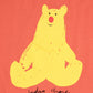 A detailed view of the yellow bear graphic on the coral T-shirt. The bear has a minimalistic, hand-drawn appearance with a round red nose, small black eyes, and a slight smile. Below the bear, "Bobo Choses" is printed in a playful, handwritten-style font.