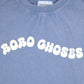 Close-up of the "BOBO CHOSES" wavy print in cream on the blue t-shirt.