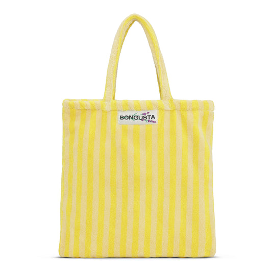 A cream and neon yellow striped classic tote bag, made of towelling fabric with a cream and neon yellow striped handle. At the top of the bag it says BONGUSTA in black inside of a cream box with green and lilac flowers coming off the words bongusta. 