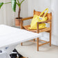A cream and neon yellow striped classic tote bag, made of towelling fabric with a cream and neon yellow striped handle sits on top of a wooden chair next to a green potted plant, in front of a white table with a dog laying on the floor and above the chair a print. At the top of the bag it says BONGUSTA in black inside of a cream box with green and lilac flowers coming off the words bongusta. 