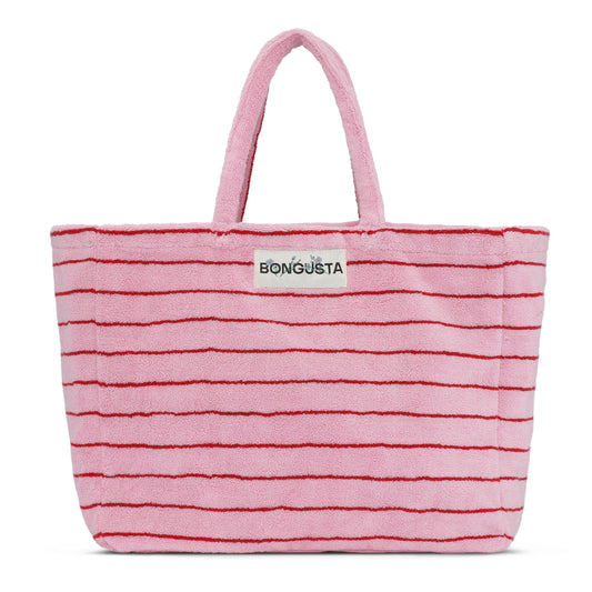 A light pink weekend style tote bag with thin red stripes, made of towelling fabric with a long pink and red striped handle. At the top of the bag it says BONGUSTA in black with green flowers coming off the letters, inside of a cream box. 