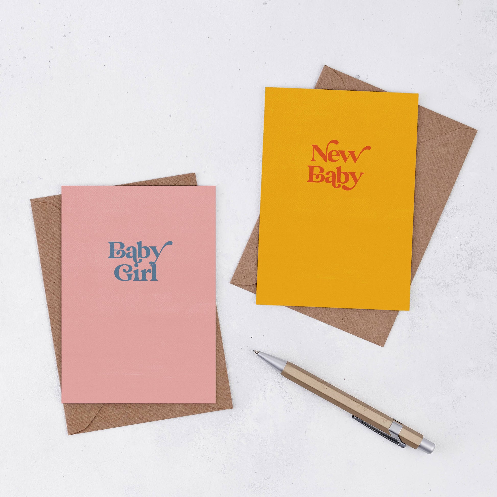 A simple pink greeting card in peachy pink with the words Baby Grirl own a retro font in grey/blue colour. Comes with a brown Kraft envelope. There is also a yellow card with the words New Baby in red writing 