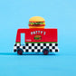 Toy truck with a hamburger on top against a blue background