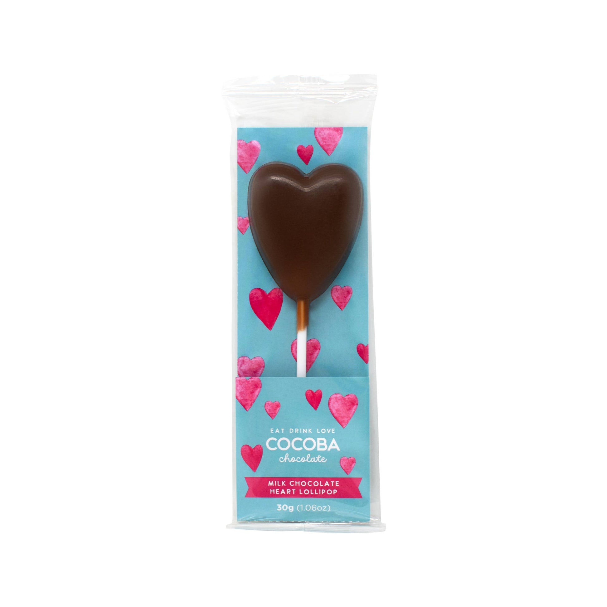 A milk chocolate lollipop in the shape of a heart on a white stick in a cellophane bag with a card insert that is blue with pink hearts printed all over it 