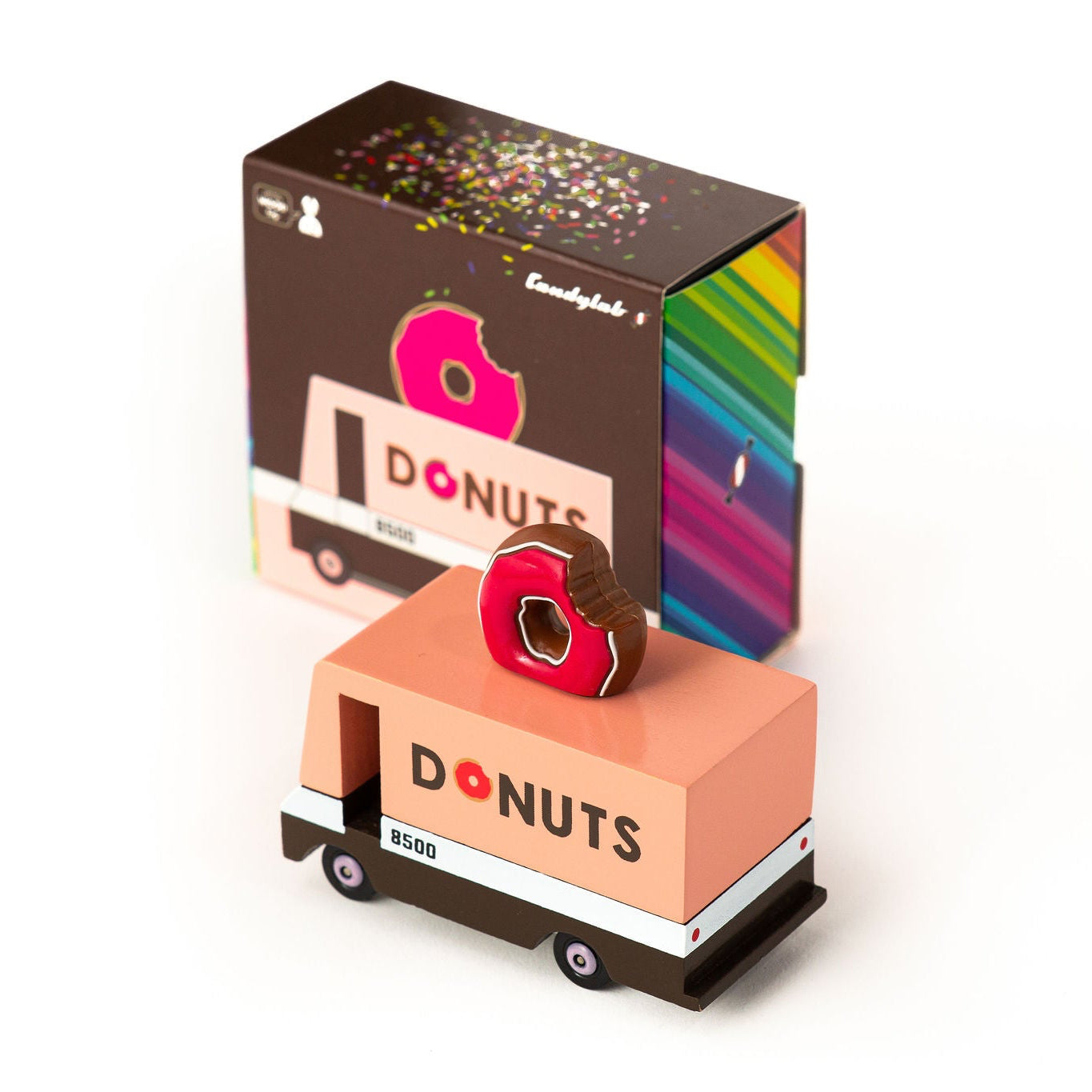 Donut-themed toy truck with a box in the background on a white background
