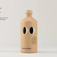 Beige bottle with black eye design on a light gray background
