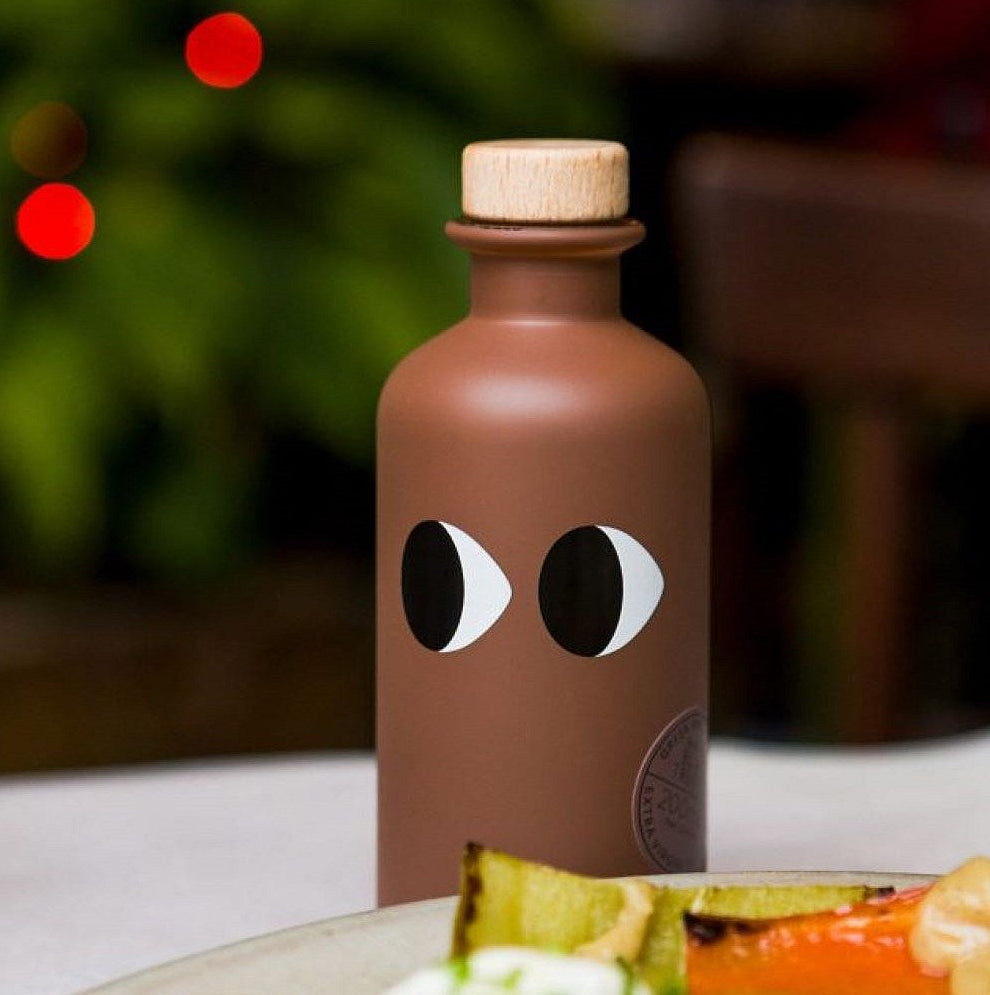 Brown bottle with googly eyes on a blurred background