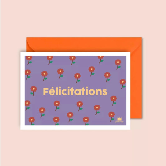 A congratulatory postcard with a lilac background featuring a repeating pattern of small red flowers. The word "Félicitations" is printed in bold, yellow lettering in the centre. The card comes with a bright orange envelope.