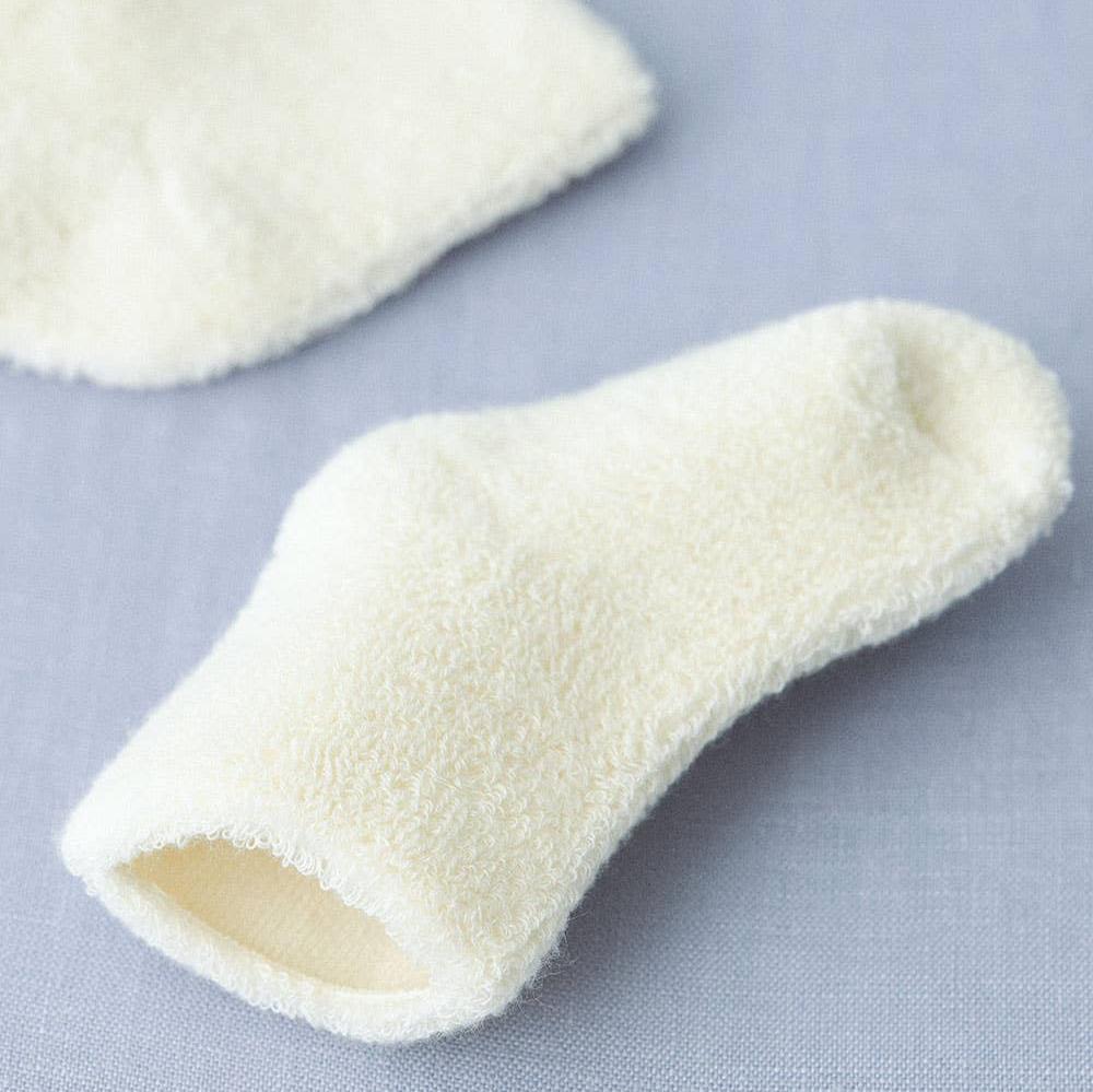 Cotton Cream baby high pile socks close up, shooing the opening of the socks with the smooth inside compared to the fluffy exterior