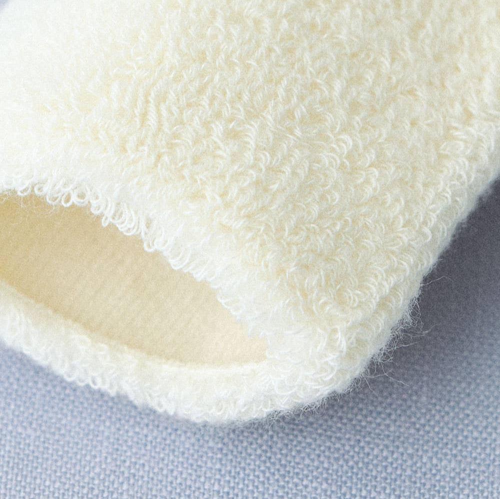 A further close up of the texture of the cream cotton socks, showing the fluffy exterior and the neat smooth interior 