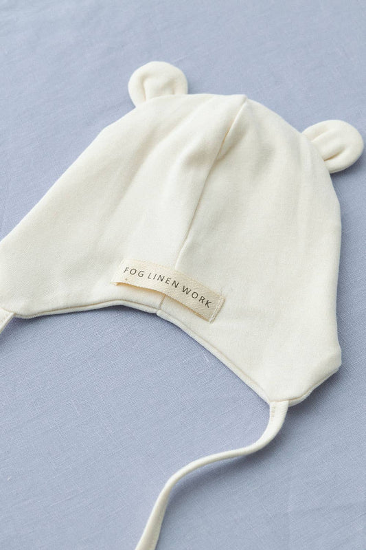 Reverse detail of Fog Linen baby pilot hat in natural ivory, made from 100% organic cotton. The hat features a lined interior for comfort, designed for newborns up to 3 months old.