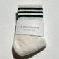 Pair of socks with striped pattern and 'Le Bon Shoppe' label on a light background