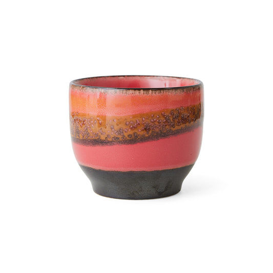 A coffee cup without a handle, with rounded bottom in a pink and speckled orange stripe, with a black bottom