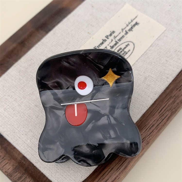 A Halloween Black Monster Hair Claw featuring a playful black monster design. This fun accessory adds a spooky touch to hairstyles, perfect for Halloween celebrations. Its secure grip keeps hair in place, making it a delightful addition to any festive look.